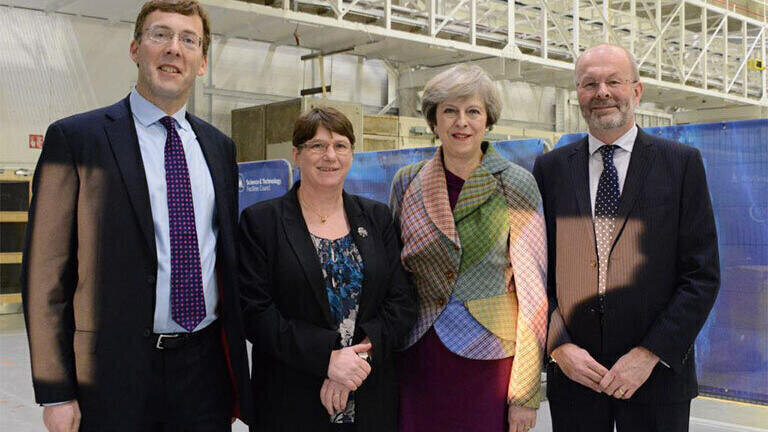 Theresa May meets Tim Bestwick (Executive Director of Business and Innovation at STFC), Susan Smith (Head of STFC Daresbury Laboratory) and Brian Bowsher (STFC Chief Executive) outside the Campus’s newest electron beam accelerator.
(Credit: STFC)
